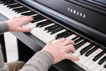 Man playing the Yamaha CLP-845 Clavinova