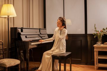 Woman playing Kawai Novus NV6 piano