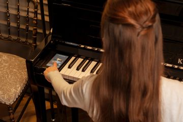 Woman using Kawai Novus NV6 control panel