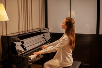 Woman playing the Novus NV6 piano