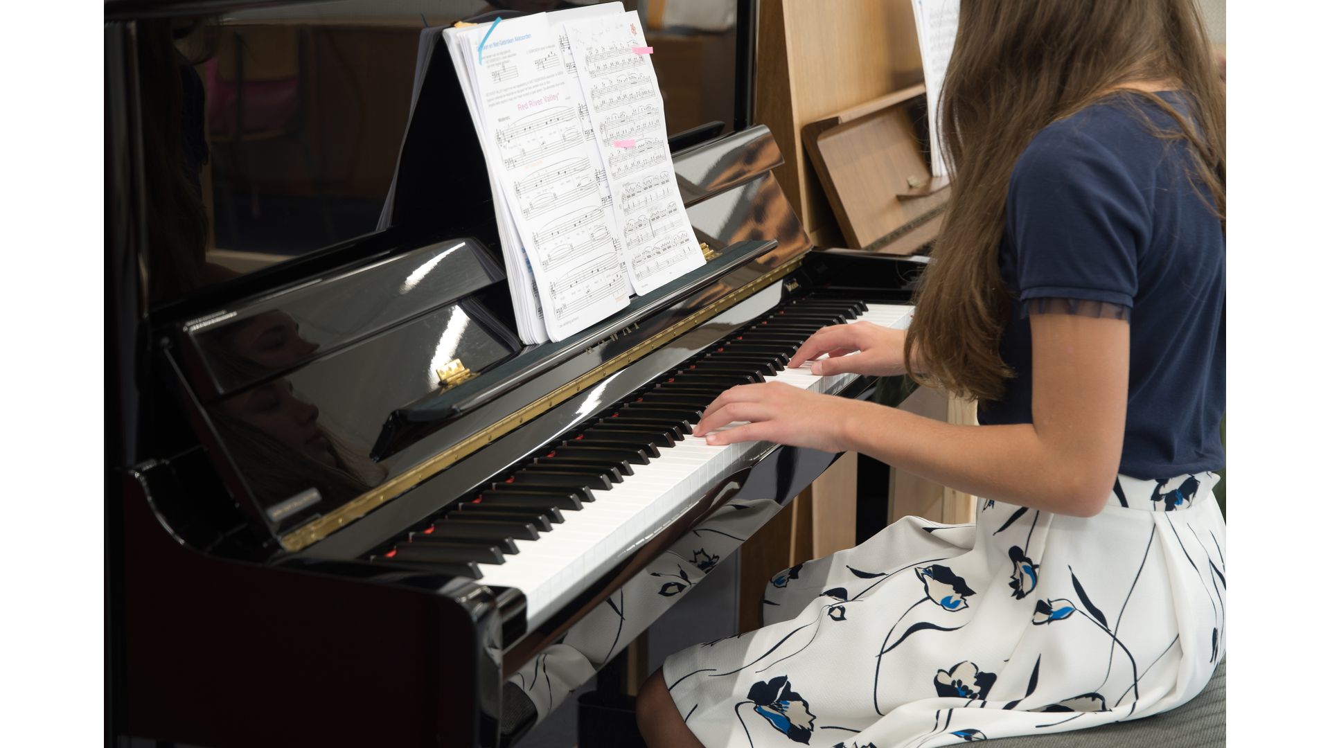 Teenage girl playing the piano