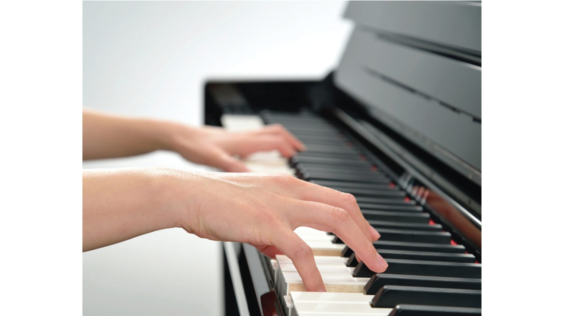 Close-up of hands playing piano keys