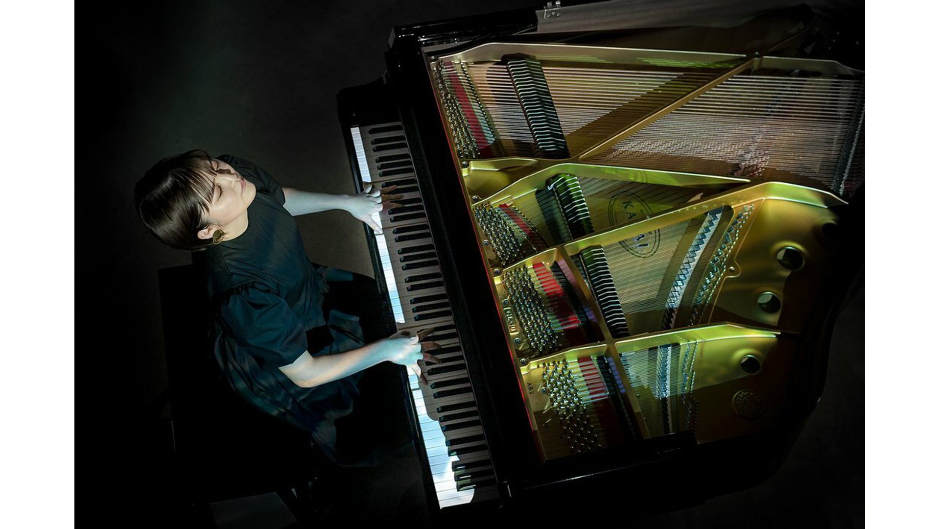 Person playing Kawai Grand silent system piano