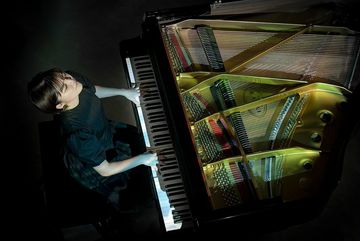 Person playing Kawai Grand silent system piano