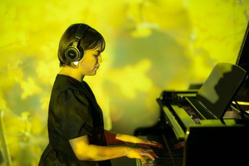 Person playing a Kawai grand piano