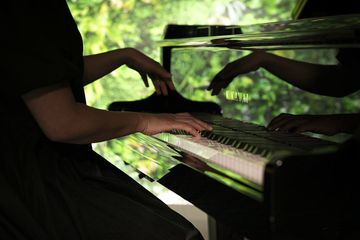 Person playing a KAWAIGRAND digital piano