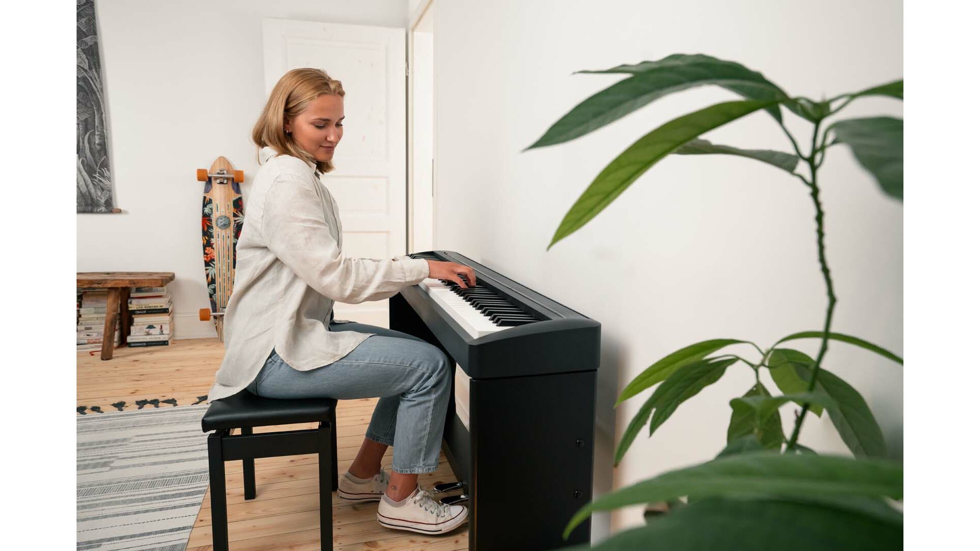 Woman playing Kawai ES120 piano