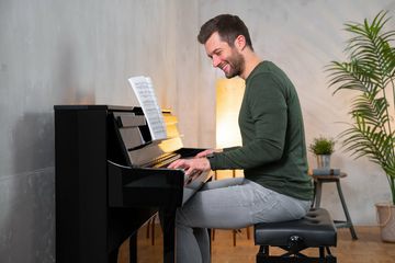 Man playing the Kawai CA901 Piano