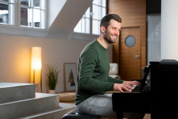 Man playing the Kawai CA901 Digital Piano