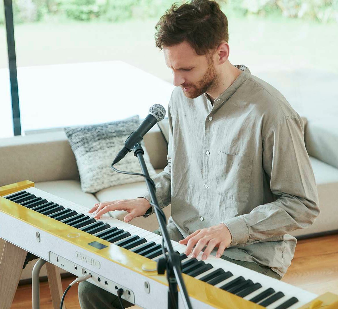 Man playing Casio's PX-S7000 digital piano